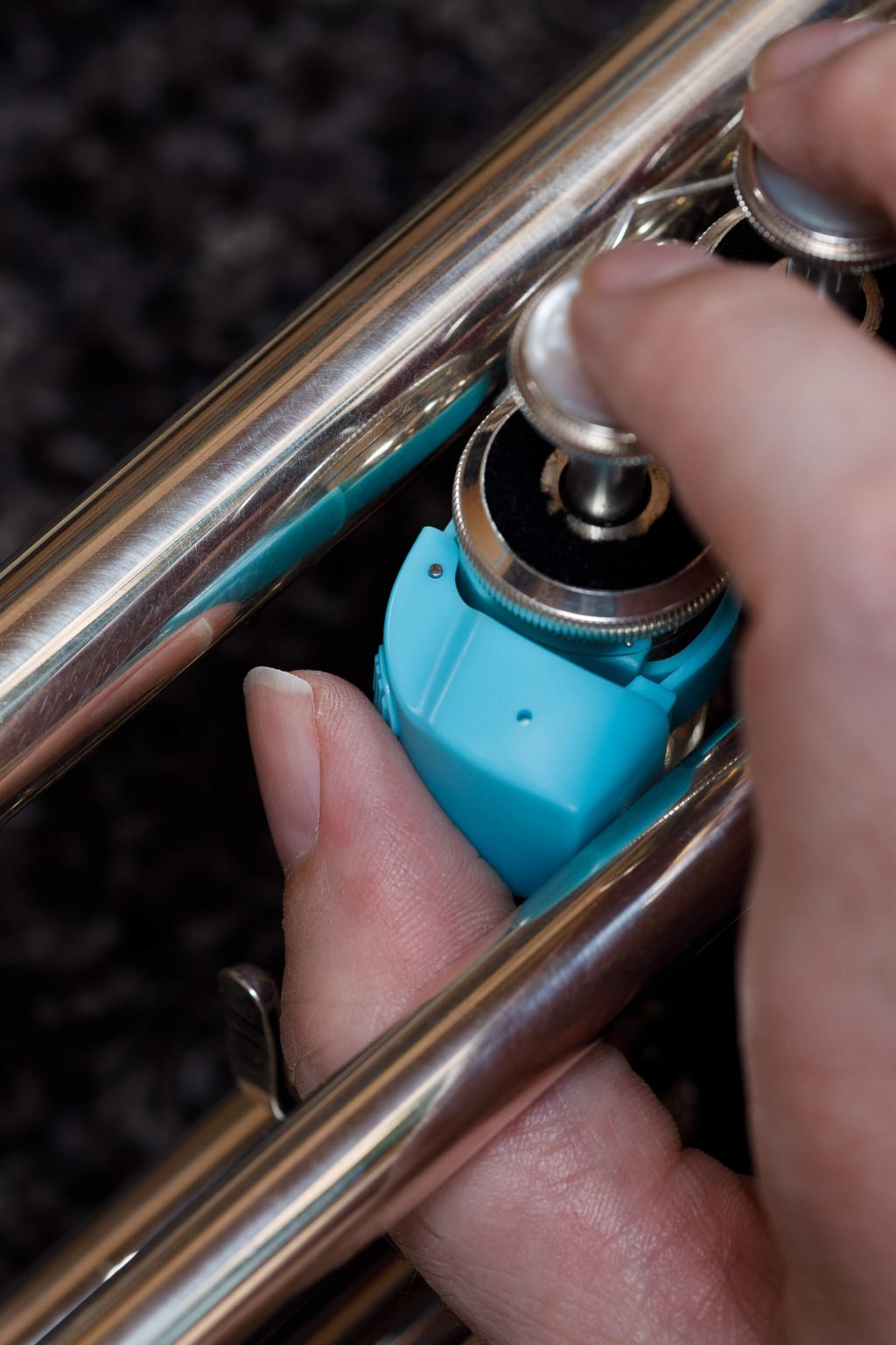 Efun Selfie-Ring R10, angebracht an einer Trompete als Page-Turner: Detailansicht Bedienung des Bluetooth-Knopfs mit dem Daumen